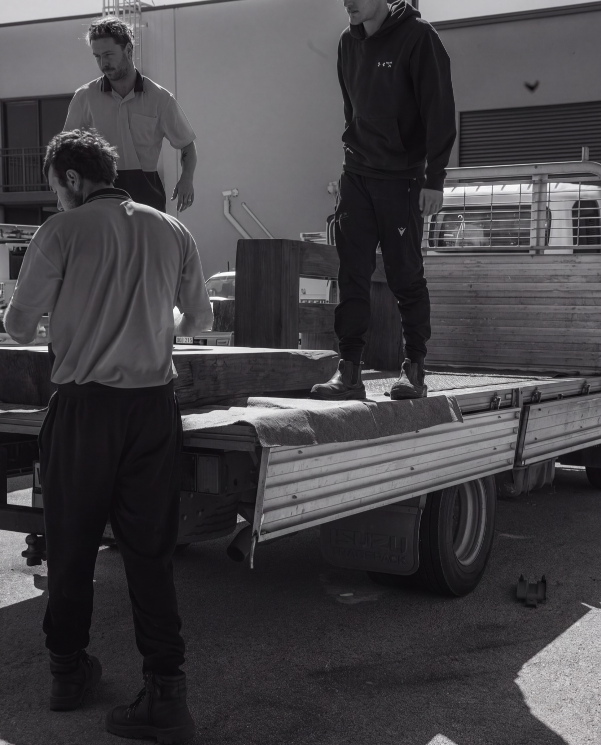 The Olive & Stone team carefully loading timber furniture onto a delivery truck